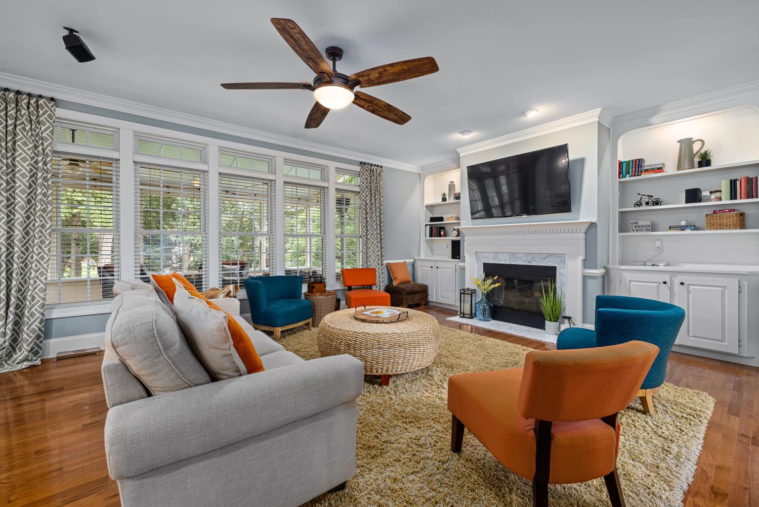 Calm living room with white sofa, wood coffee table, flowers, and warm natural decor